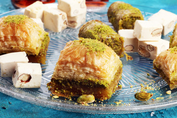 Middle eastern or arabic dishes. Turkish Dessert Baklava with pistachio on dishes
