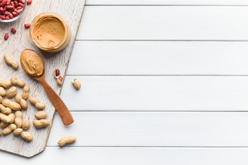 Bowls with peanuts and jar of peanut butter