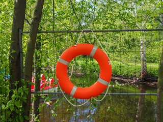 Safety equipment, lifebuoy hanging on the fence near the boat station