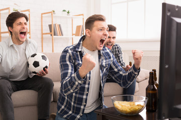 We Win! Emotional Football Fans Watching Match On Tv