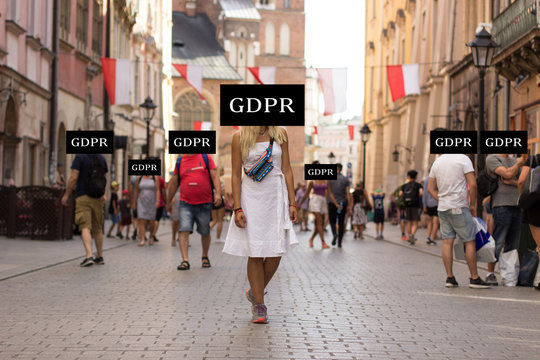 GDPR privacy data protection law in European Union countries concept picture of people with incognito faces behind black graphic inscription plate in Poland medieval city street landmark environment 