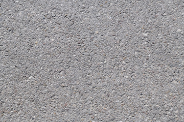 Fototapeta premium Asphalt background texture with some fine grain under the sun