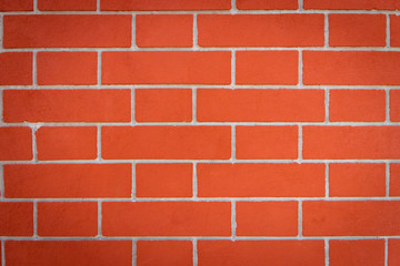 Obraz premium orange and red brick wall on a building in Eruope - for background and texture use