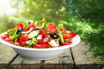 Close-up photo of fresh salad with vegetables in white plate