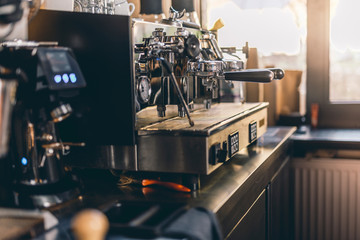 Soft light in the cafe kitchen with espresso machine on the table
