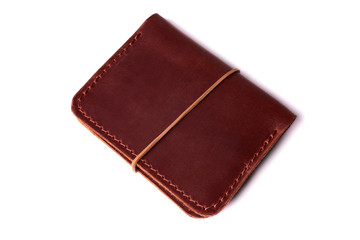 Handmade red color leather cardholder with rubber band isolated on white background closeup. Stock photo of handmade luxury accessories.