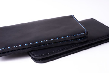 Two handmade leather black purse isolated on white background. Stock photo of luxury accessories.