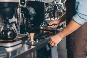 Barista shaking out the filter holder after using it