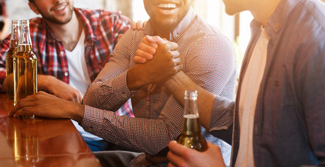 Men Greeting. Friends Shaking Hands And Driking Beer