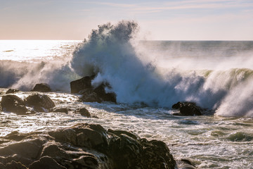Fototapeta na wymiar Waves of Atlantic Ocean crashing on rocks in Porto, Portugal