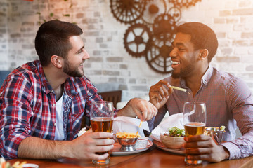 Rest In Bar. Men Drinking Beer And Eating French Fries