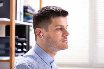 Wireless Earphone In Man's Ear