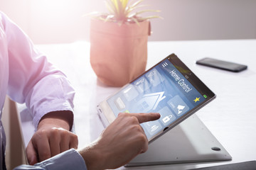 Person Using Home Control System On Laptop