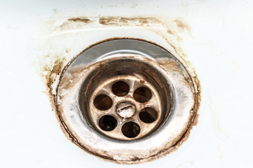 Dirty sink drain mesh, hole with limescale or lime scale and rust on it close up, dirty rusty...