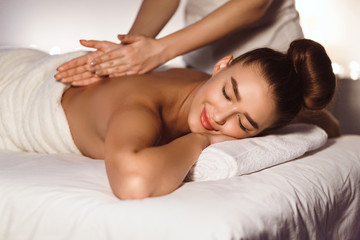 Fototapeta na wymiar Body Care. Woman Enjoying Back Massage In Spa