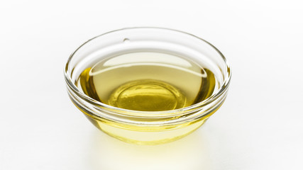 Glass bowl with oil on white