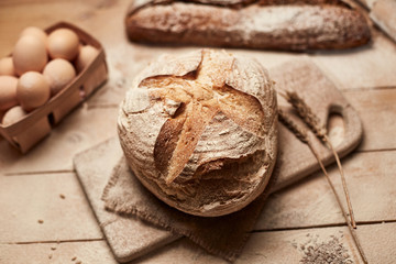 Fresh homemade bread on wooden background. Crisp. French bread. Bread at leaven. Unleavened bread.