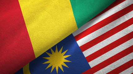 Fototapeta premium Guinea and Malaysia two flags textile cloth, fabric texture