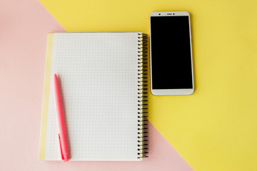 Creative flat lay photo of workspace desk with smartphone,and notebook with copy space background, minimal style