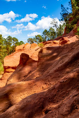 Large colorful ochre deposits, located in Roussillon, small Provensal town in  Natural Regional Park of Luberon, South of France