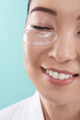 Cropped photo of Asian woman with pure fresh skin situating in studio