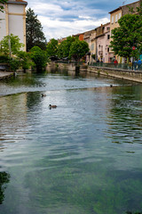 Tourist and vacation destination, small Provencal town lIsle-sur-la-Sorgue with green water of Sotgue river