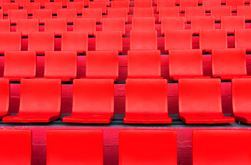 rows of red seat pattern in football or soccer sport stadium