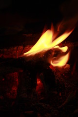 Glowing Yellow and orange colour fire is flamming and burning on a black background.Abstract design