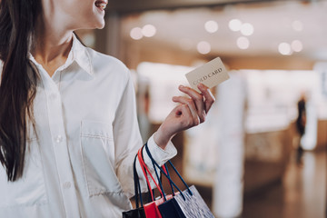Cheerful young female is going on shopping