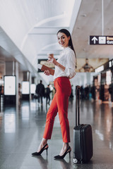 Happy woman with coffee is ready for boarding