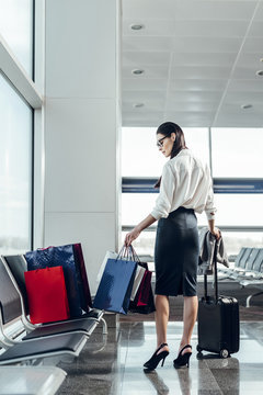 Businesswoman is travelling with baggage by air