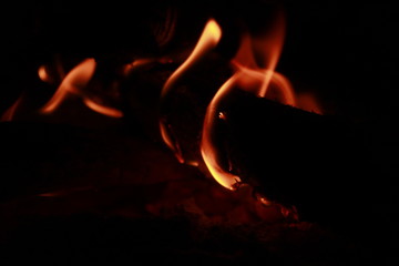 Glowing Yellow and orange colour fire is flamming and burning on a black background.Abstract design