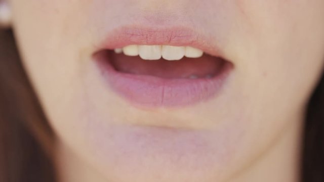 Close up of female mouth talking to camera 