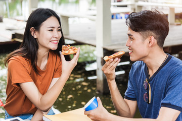 Students group woman and man eating pizza together