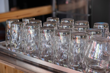 A tall, clear glass tea cup in a coffee shop.
