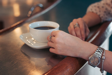 Coffee on the table the girl's hands croissants