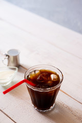 glass of iced coffee on white wooden table