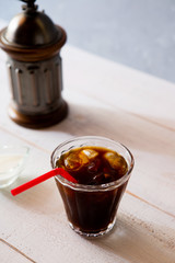glass of iced coffee on white wooden table