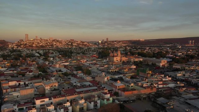 Aerial drone sunset over the Santa Clara Temple and the Aqueduct of Queretaro City, Mexico
