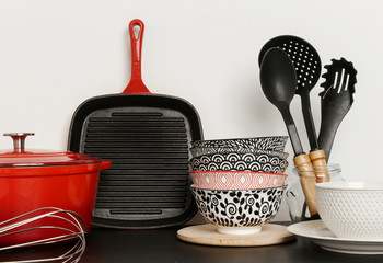 Cookware set: Red enameled cast iron pot, saucepan and bowls