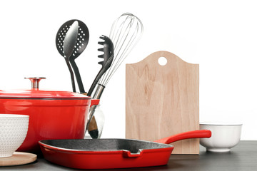 Cookware set: Red enameled cast iron pot, saucepan and bowls 