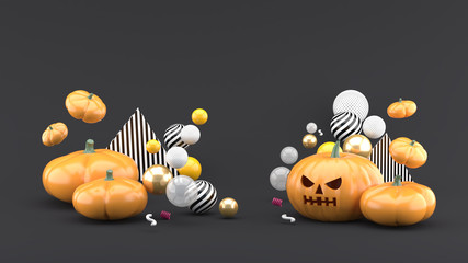 Pumpkin Halloween is among the colorful balls on the  gray background.-3d rendering.