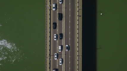 Drone's Eye View - Top down view from above of urban traffic jam with cars and truck on bridge