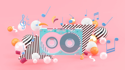 Fototapeta na wymiar Music Tape among the colorful balls on the pink background.-3d rendering.