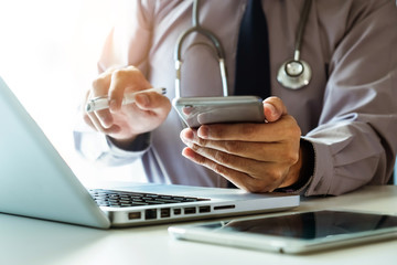 Medical technology concept. Doctor working with mobile phone and stethoscope and digital tablet...