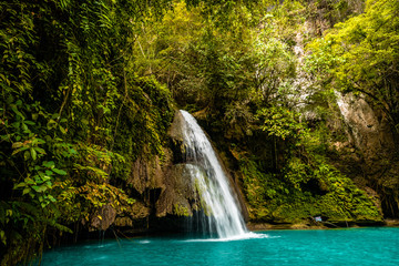 Fototapeta na wymiar Kawasan Falls on Cebu island in Philippines, turquoise waterfalls