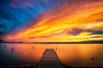 Naklejka na ściany i meble Beautiful Sunset Clouds over horizon and fishing pier