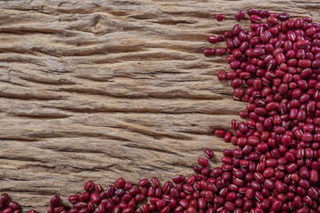 Red bean seeds on a wooden background in the kitchen