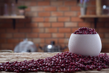Red bean seeds on a wooden background in the kitchen
