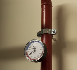 A number of identical manometers stand on plastic pipes with red valves